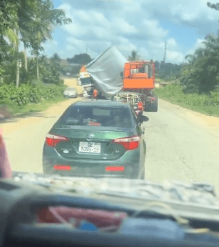 Driver feared dead after heavy load under escort fell onto truck at Assin Fosu